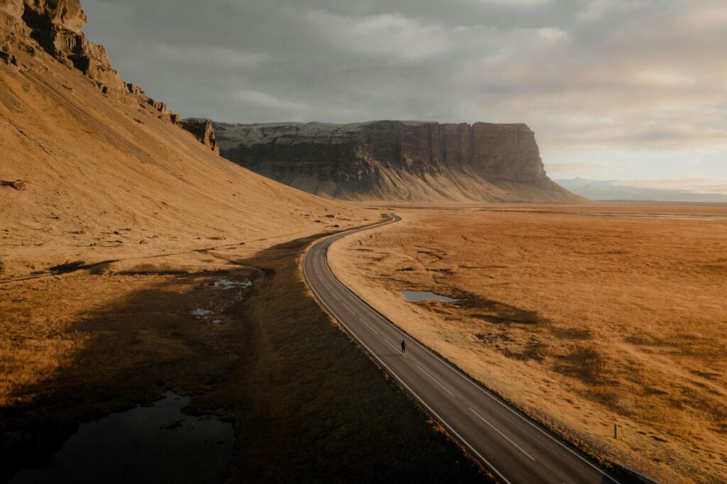 pexels-photo-15041149-15041149 Breathtaking view of a winding road through Iceland's stunning landscape, captured near Kálfafell.
